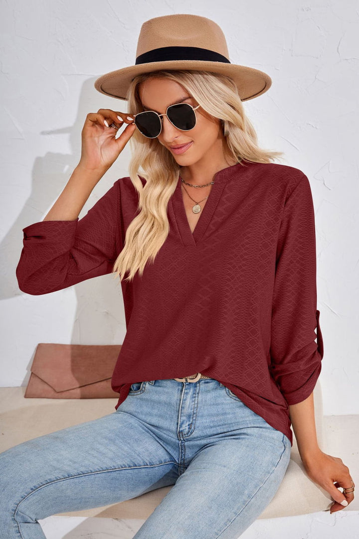 Textured split v-neck blouse with roll-tab sleeves