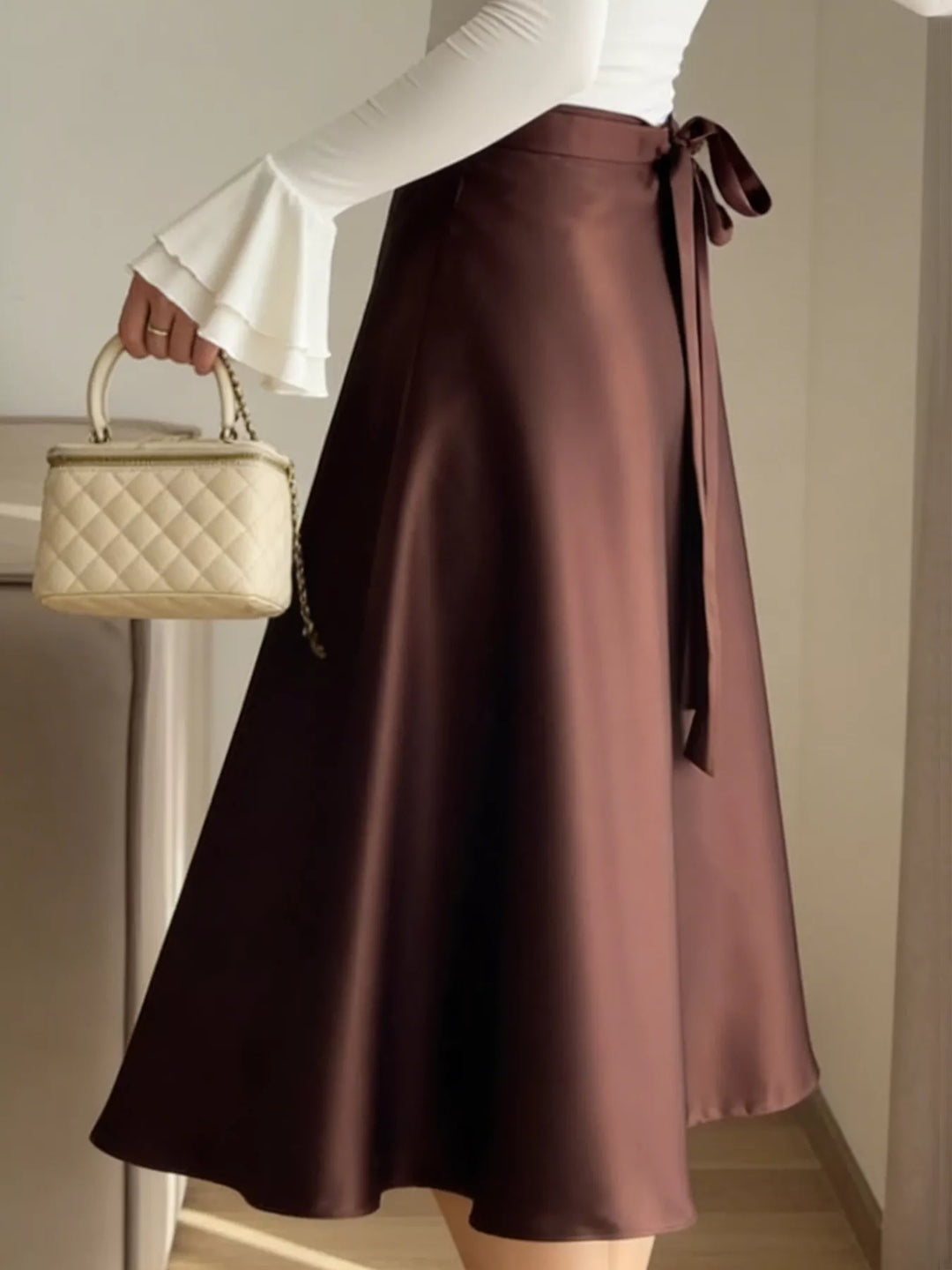 High-waist satin A-line midi skirt with tie bow