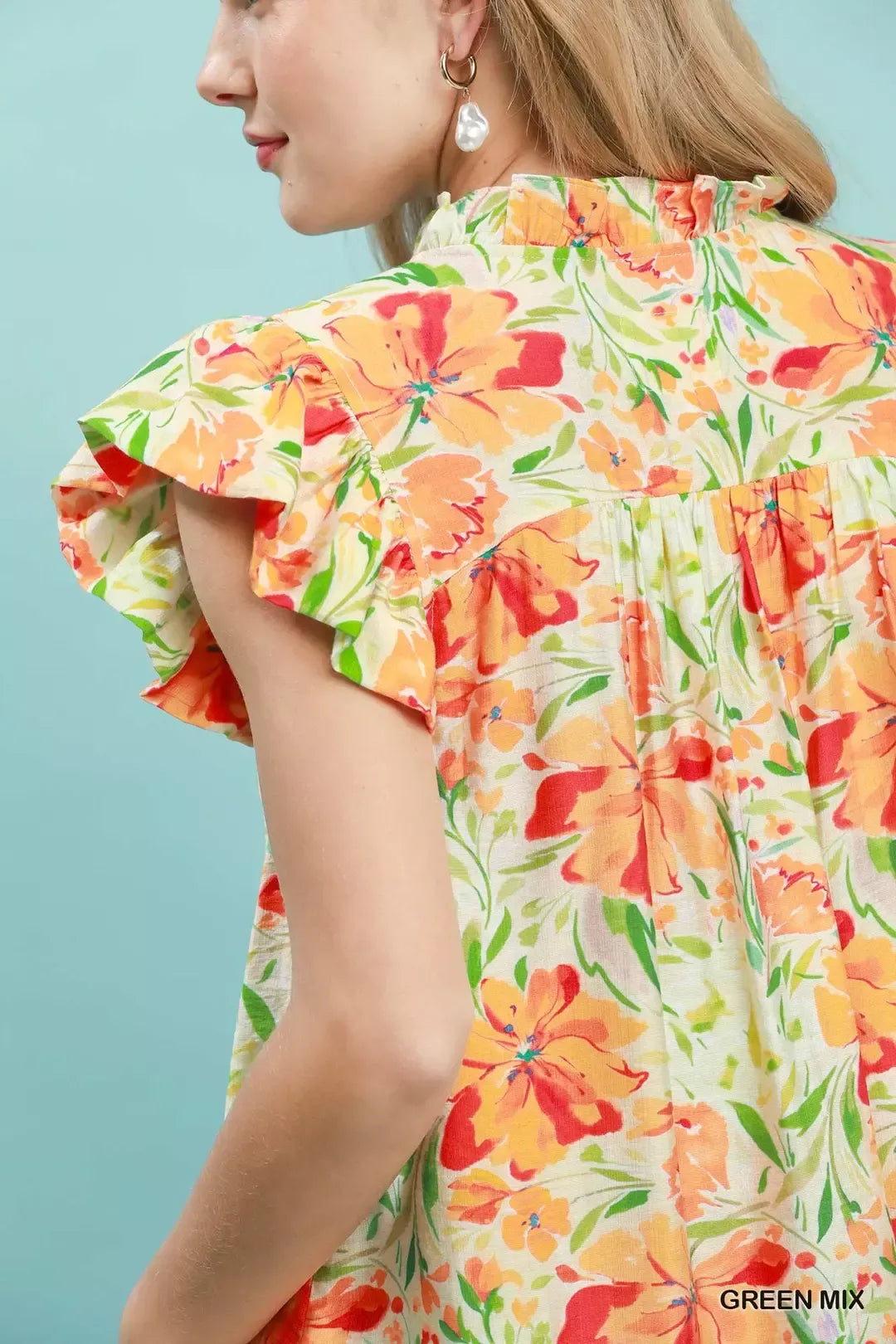 Smocked yoke flutter sleeve floral blouse with split V-neck