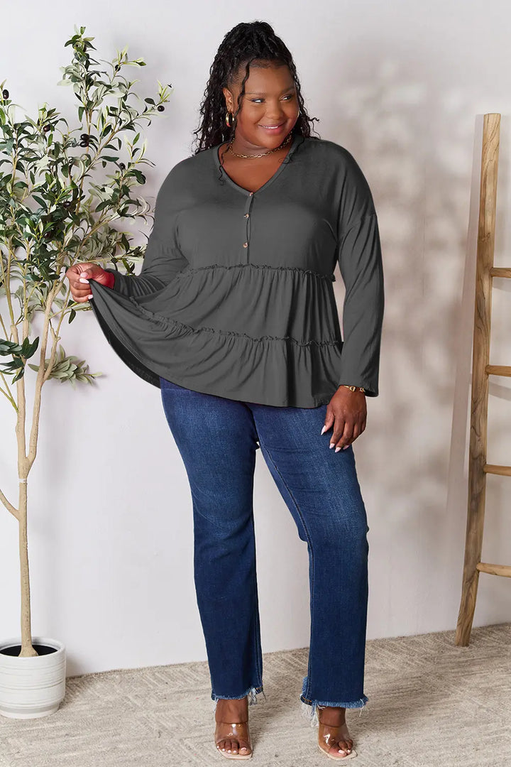 Half-button long sleeve blouse with tiered ruffle hem