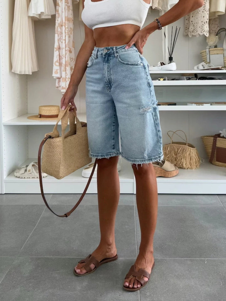 Distressed high-rise longline denim shorts with raw hem