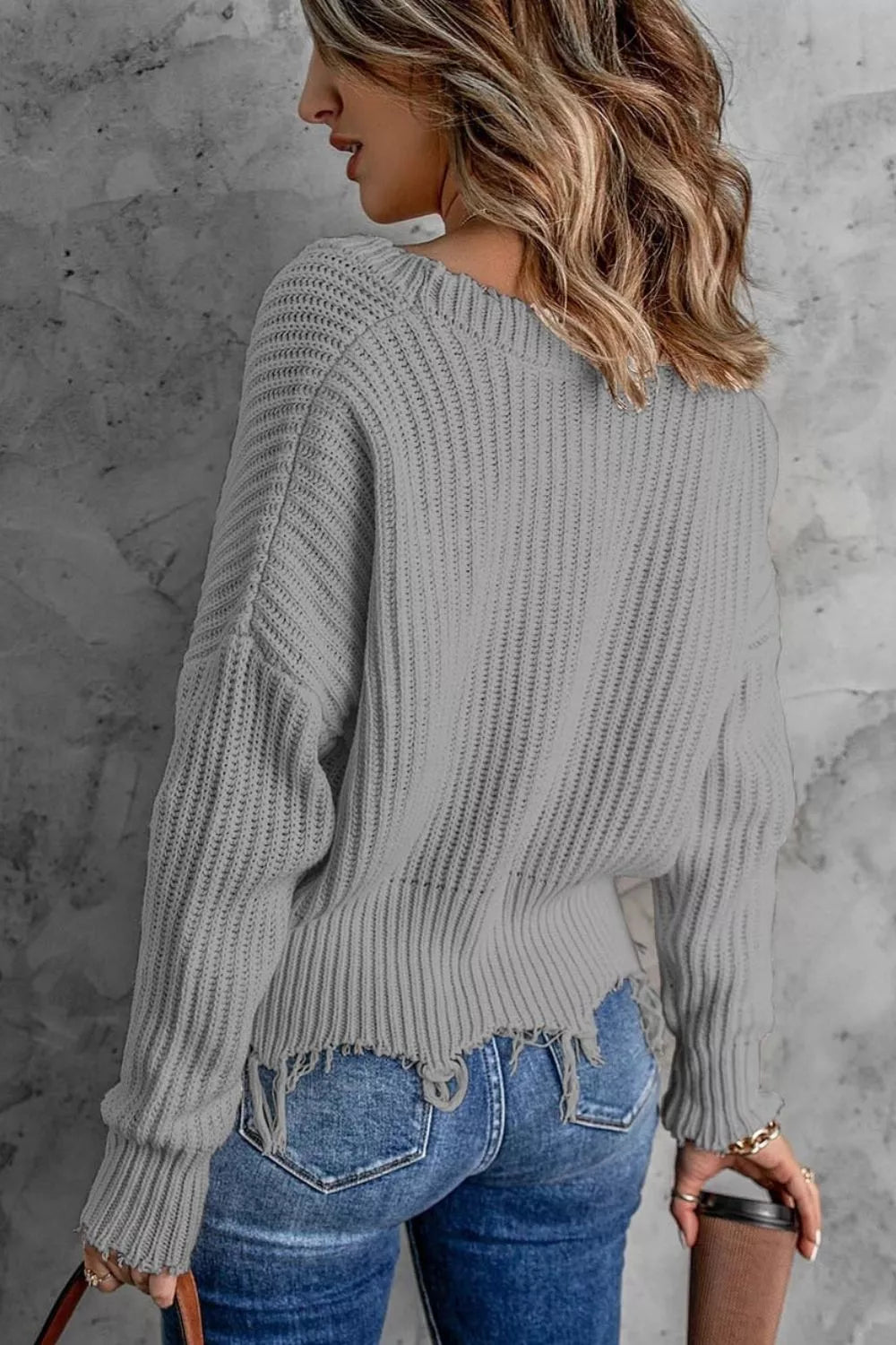 Distressed raw hem ribbed knit V-neck sweater
