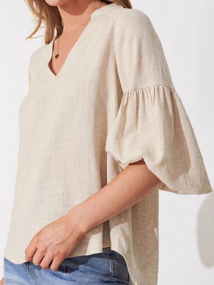 Balloon sleeve blouse with notched neckline and high-low hem