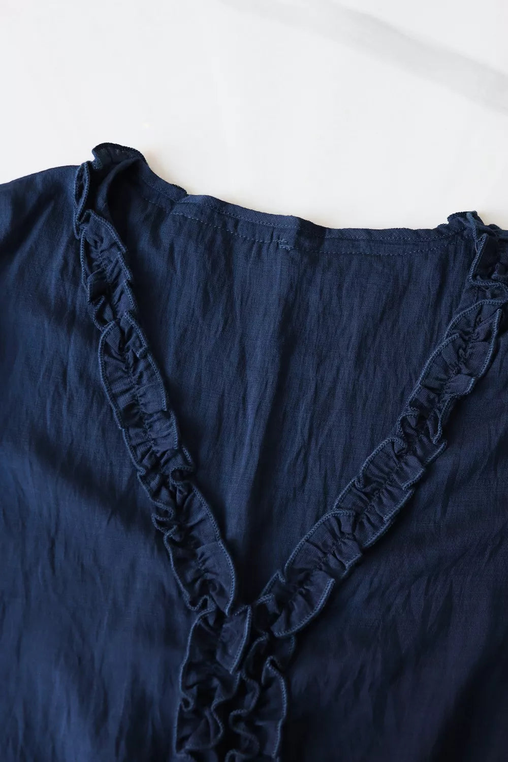 Ruffle hem V-neck blouse with embroidered yoke and lace-trim sleeves