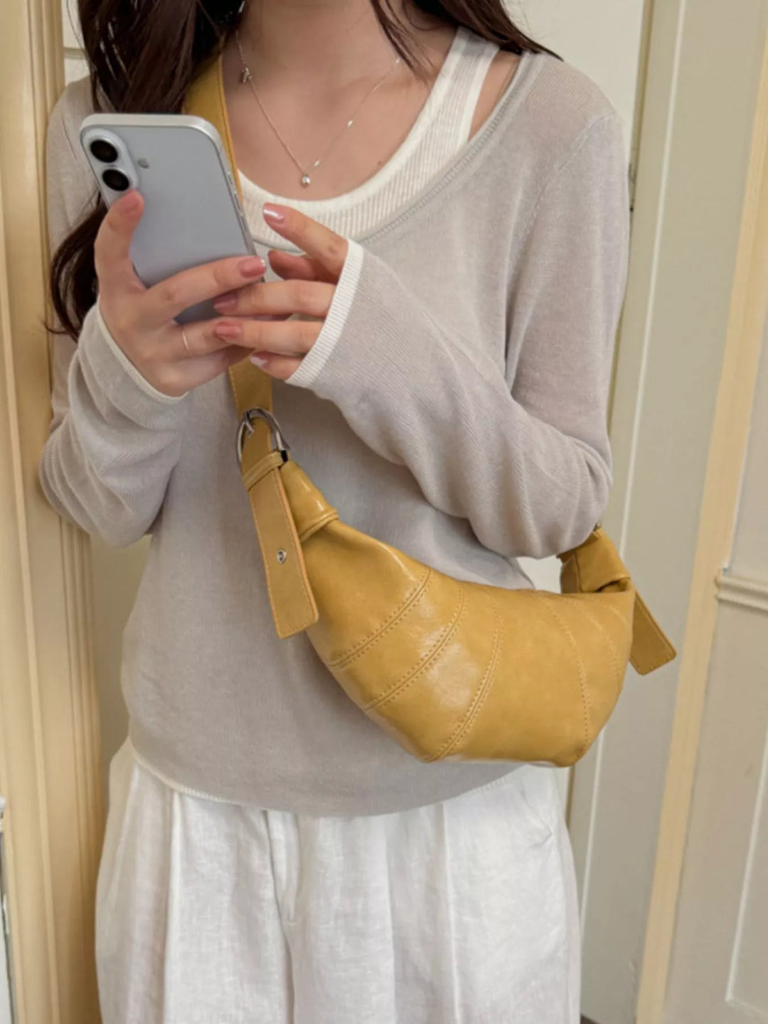 Croissant crossbody bag with adjustable strap and zip top