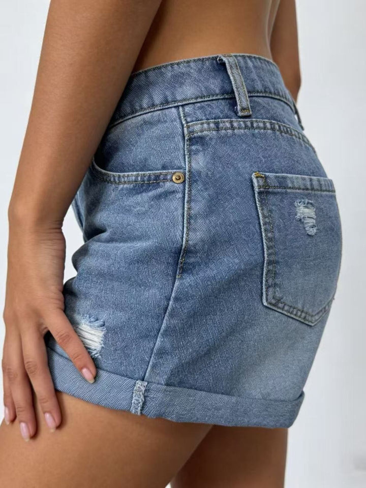 High-rise distressed denim shorts with cuffed hem