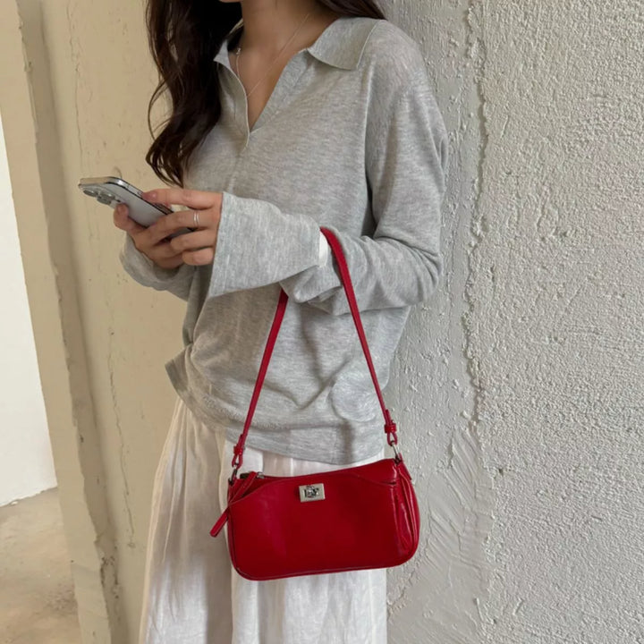 Faux leather baguette shoulder bag with twist lock