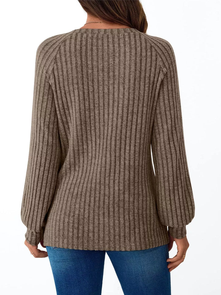 Ribbed knit long sleeve top with decorative shoulder buttons