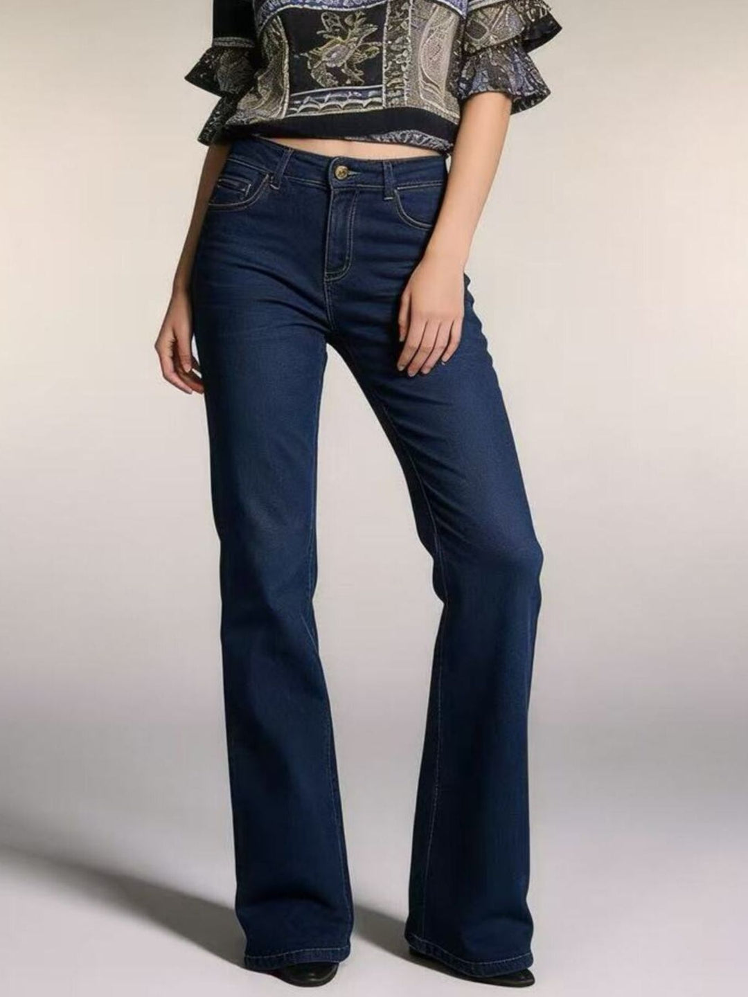 Medium High-rise bootcut jeans with yoke seam and raw hem