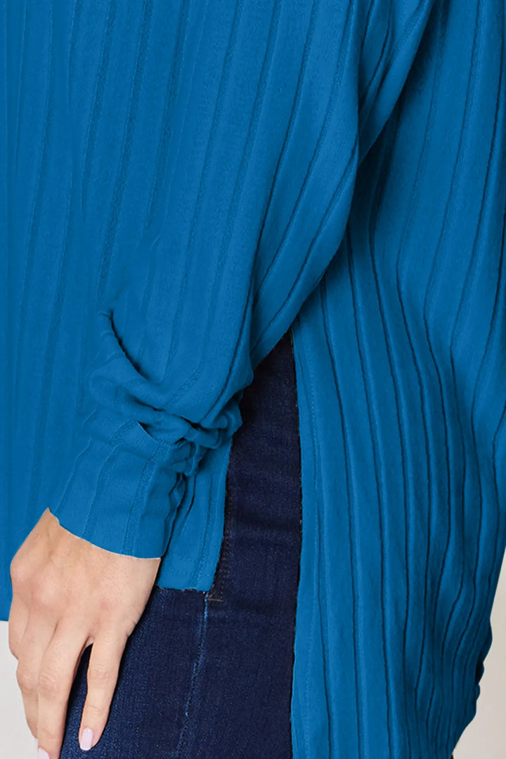 Ribbed knit round neck long sleeve top with side slits