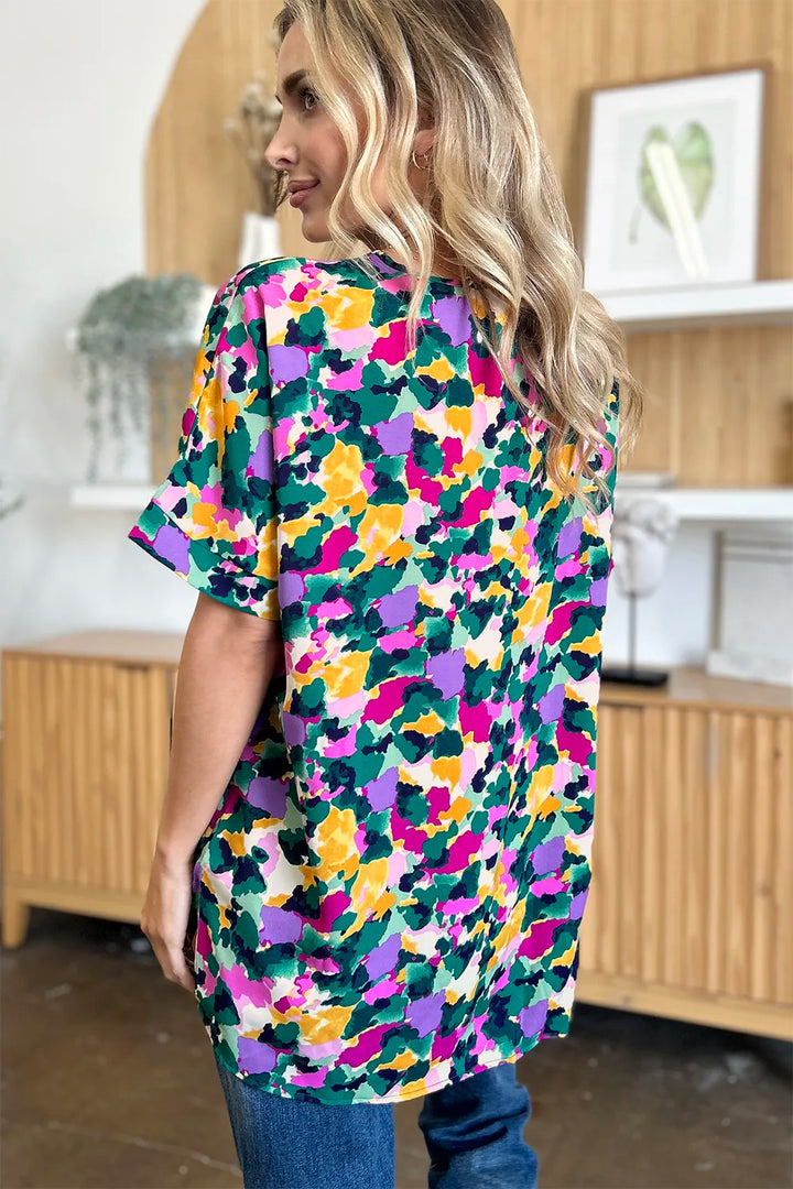 Abstract print v-neck tunic top with flutter sleeves and side slits