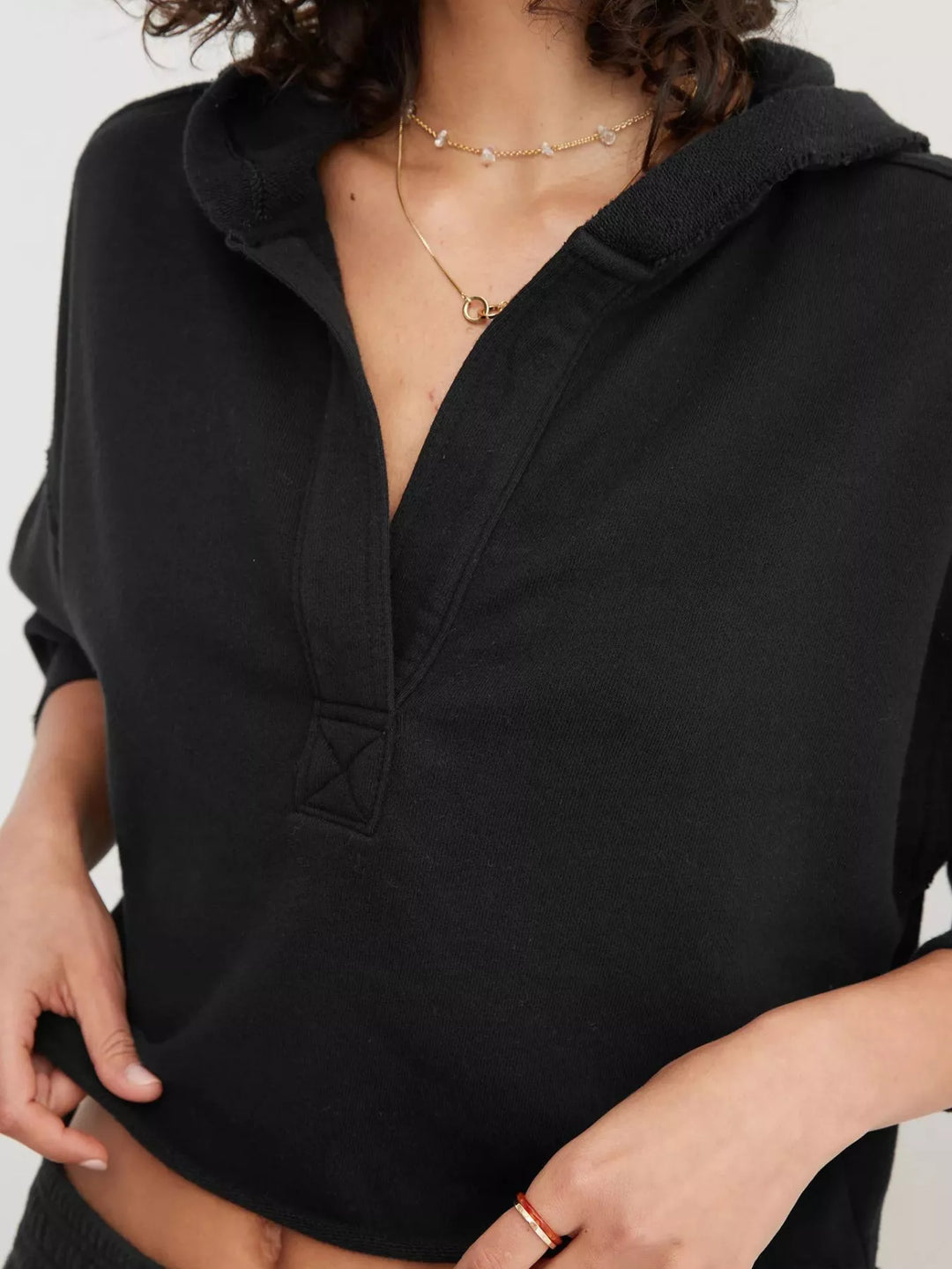 Cropped exposed-seam pullover hoodie with split neck