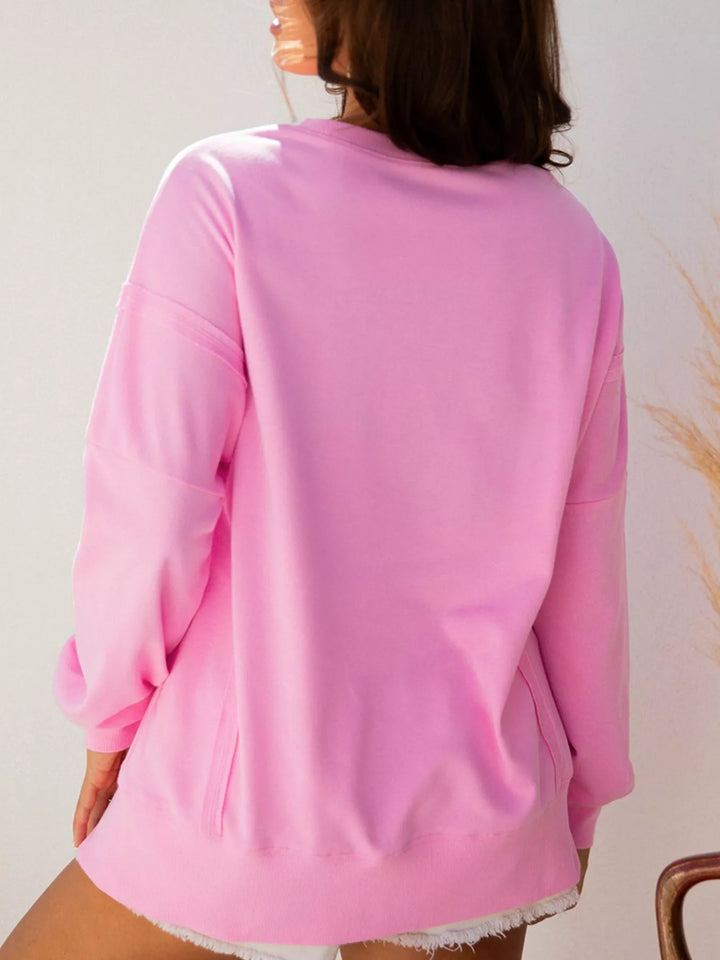 Oversized XOXO graphic sweatshirt with exposed seams and bows