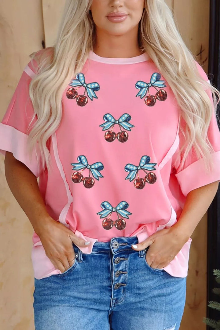Sequin cherry and bow graphic raw seam crew neck top