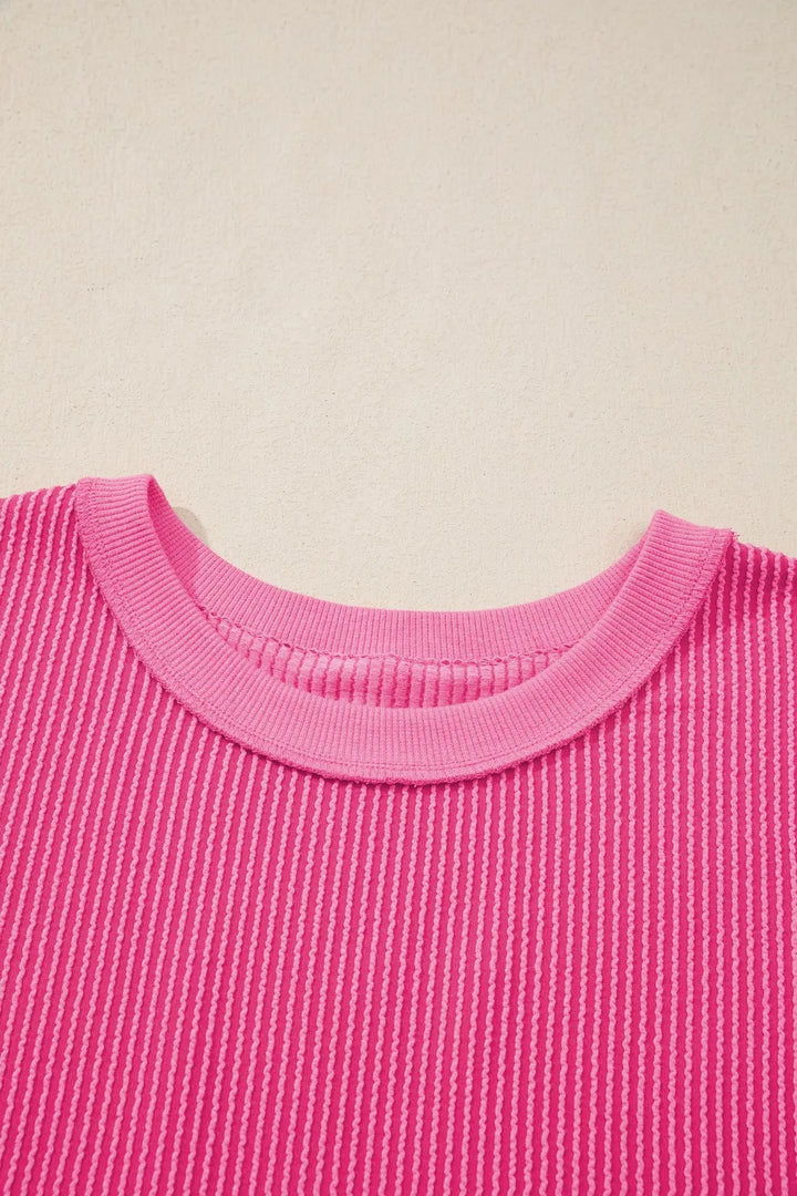 Ribbed knit short sleeve top with cutout bow-tie back