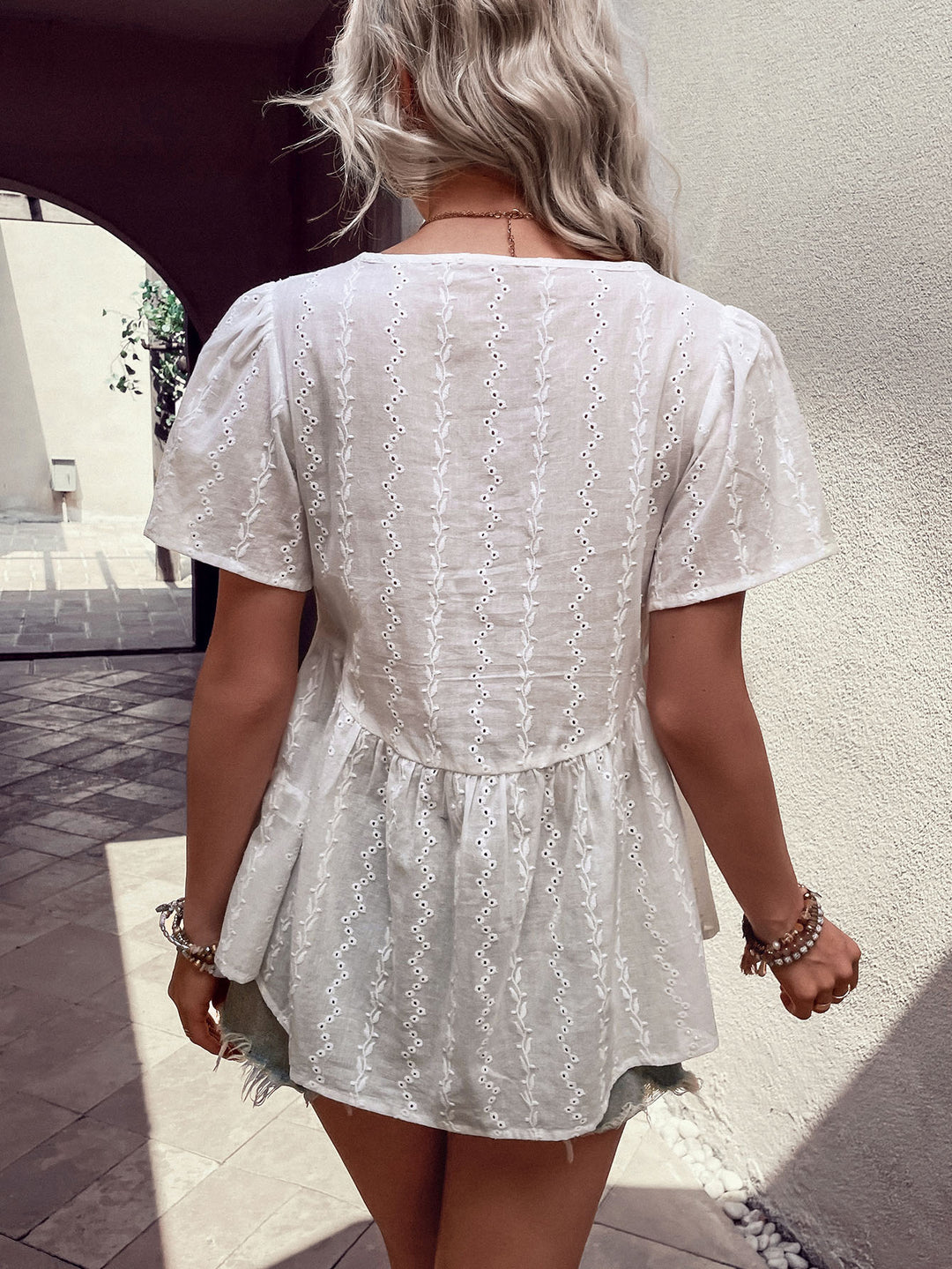 Eyelet tie-neck puff sleeve peplum blouse