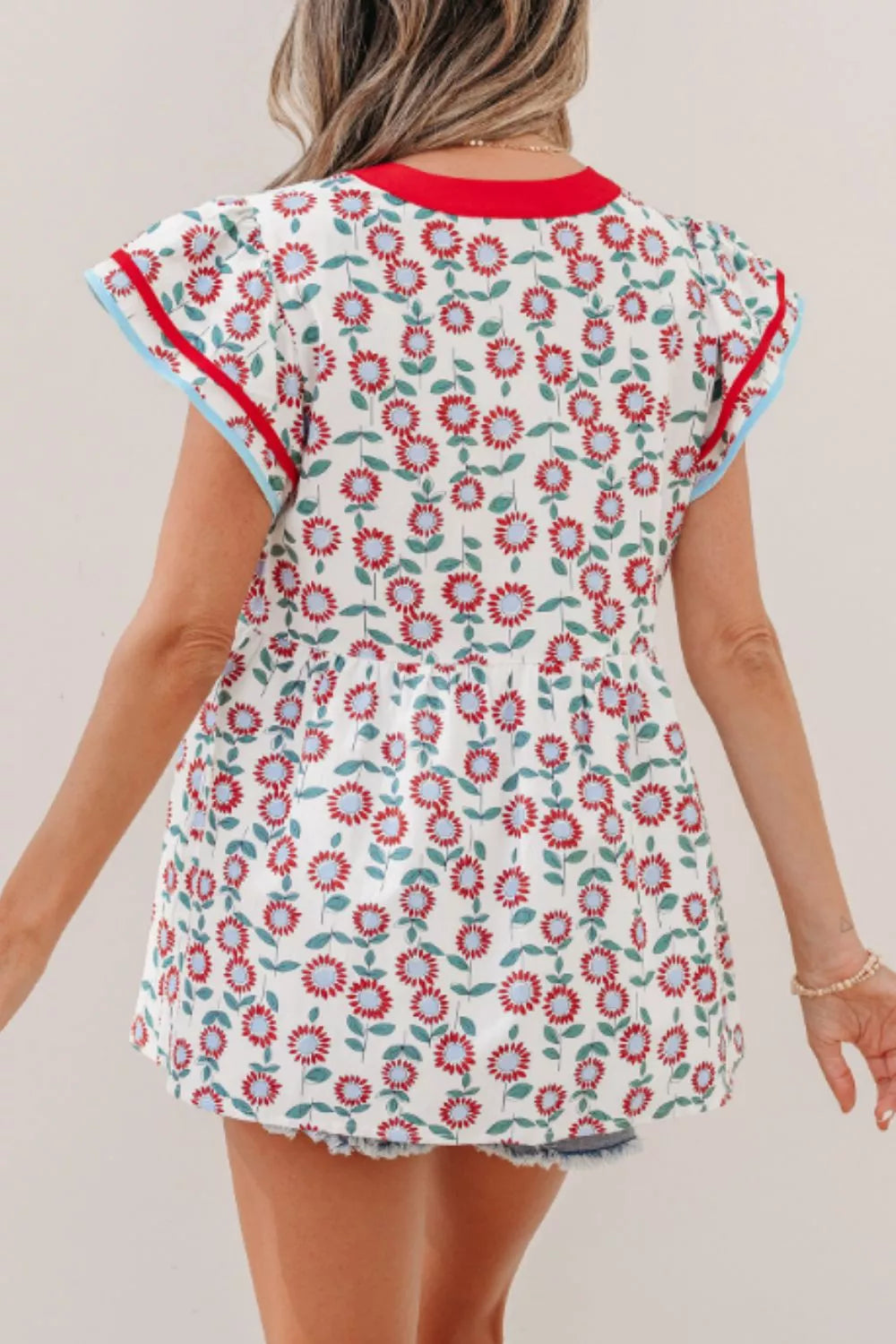 Floral babydoll blouse with ruffle cap sleeves and striped V-neck