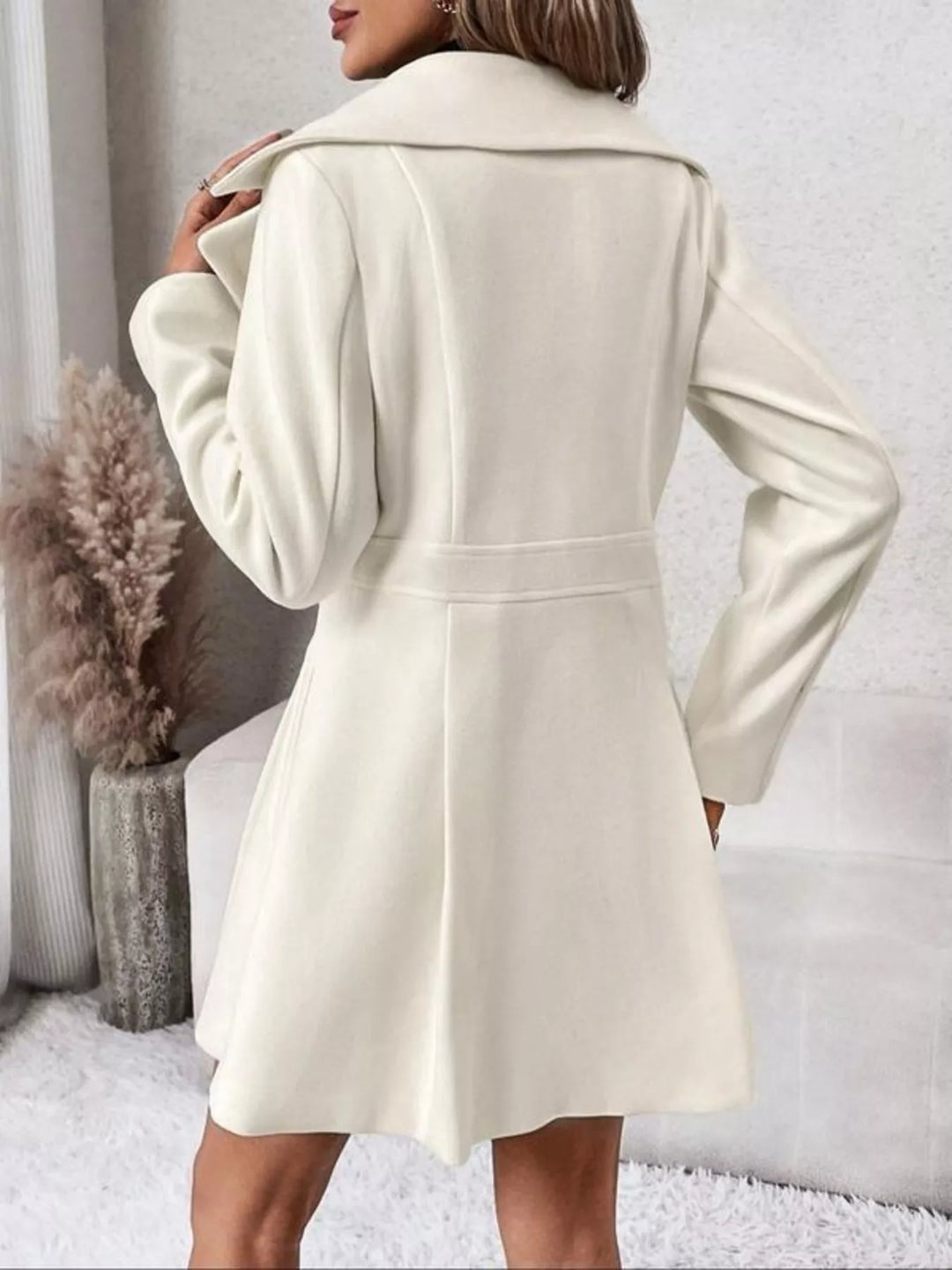Double-breasted peplum coat with notch lapels and pockets