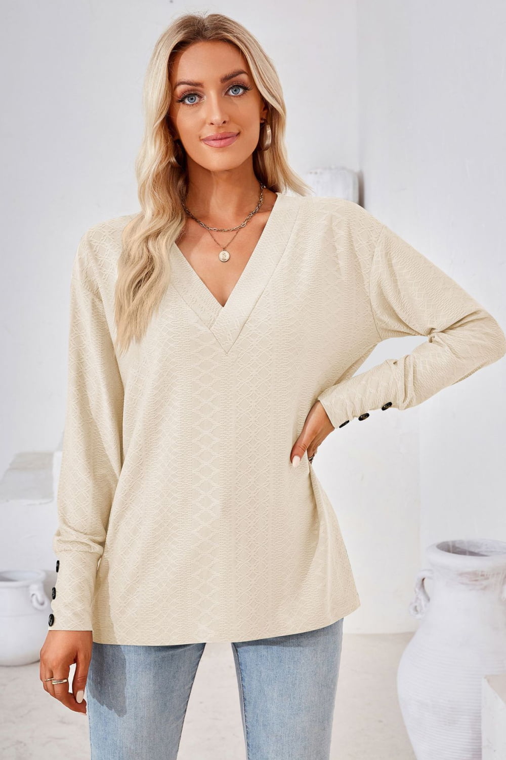 Textured knit V-neck long sleeve top with button cuffs