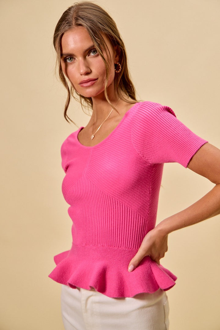 Ribbed knit peplum top with short sleeves and scoop neck