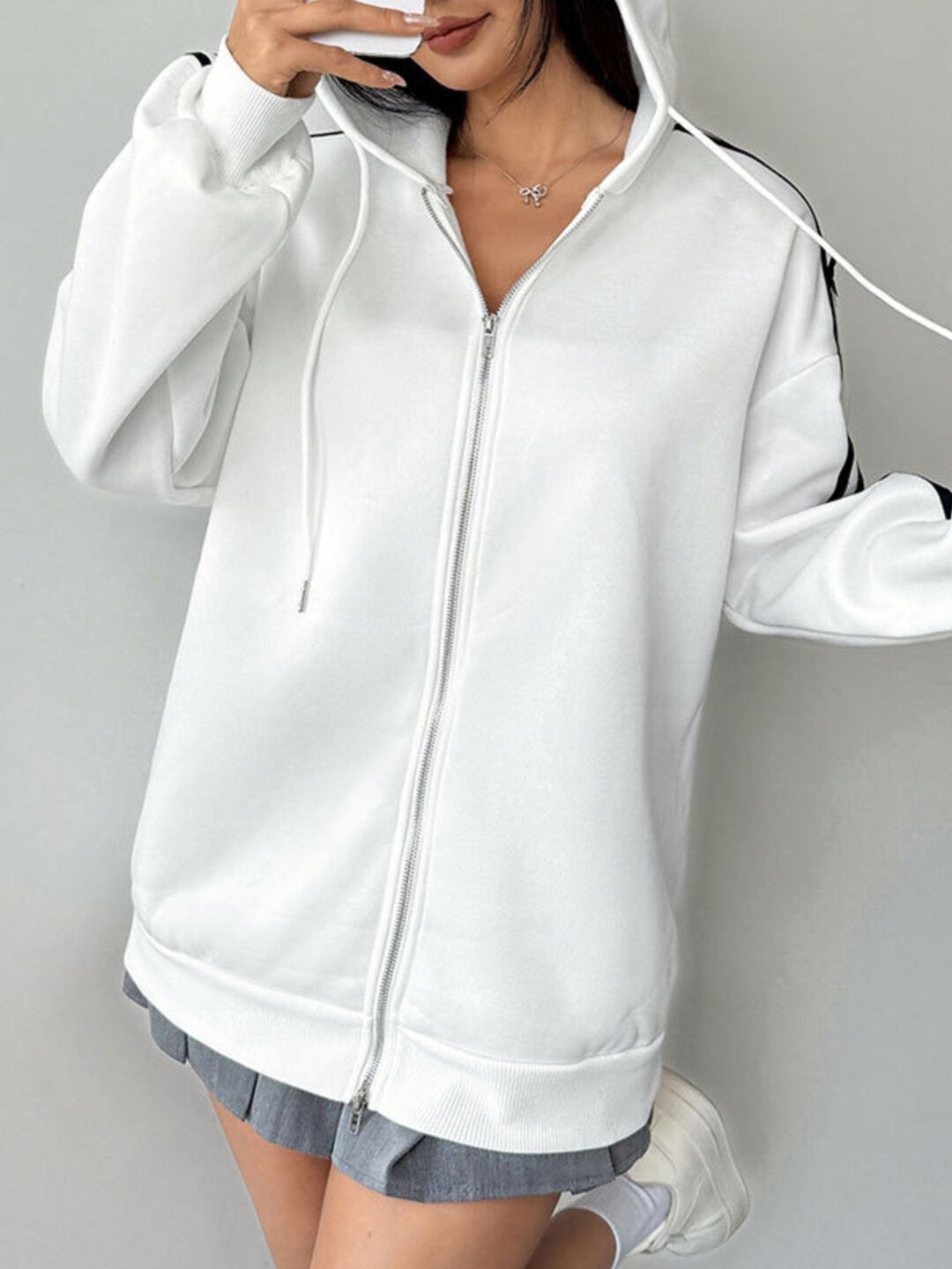 Zip-up hoodie with striped sleeves and bow detail