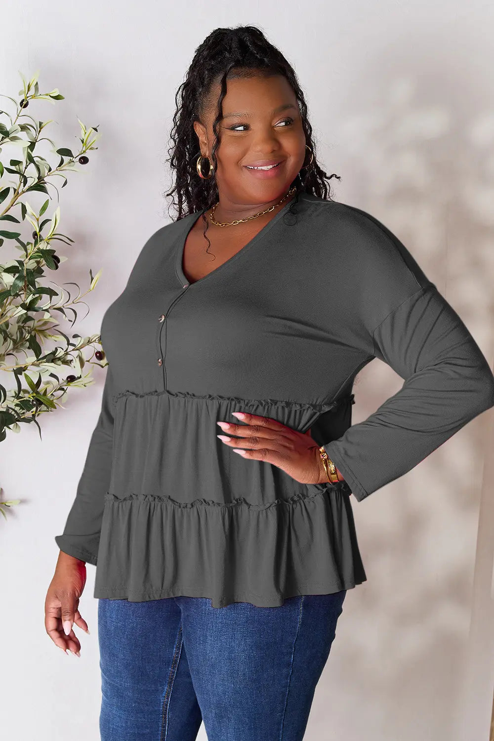 Half-button long sleeve blouse with tiered ruffle hem
