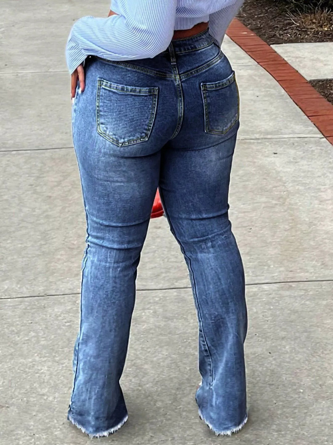 High-rise ripped knee flare jeans with raw hem