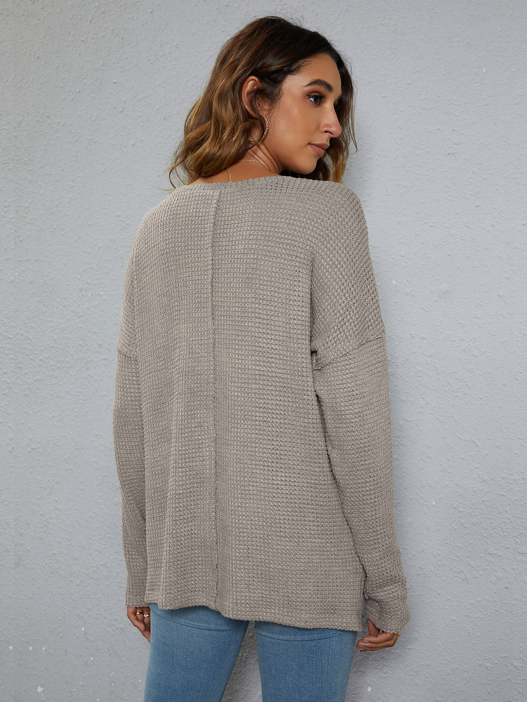 Dropped-shoulder waffle-knit V-neck top with high-low hem