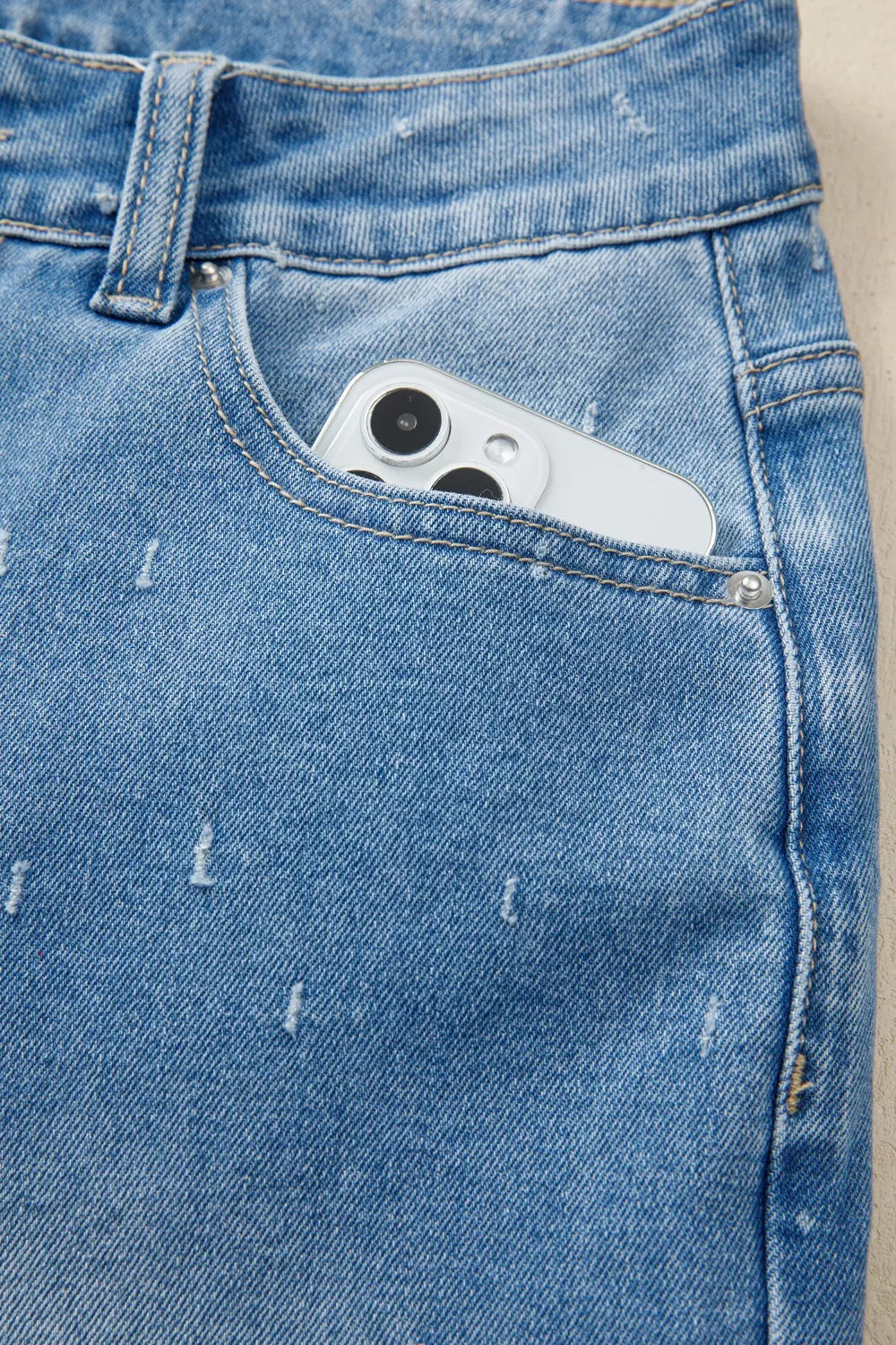 Distressed wide-leg jeans with tummy control and raw hem
