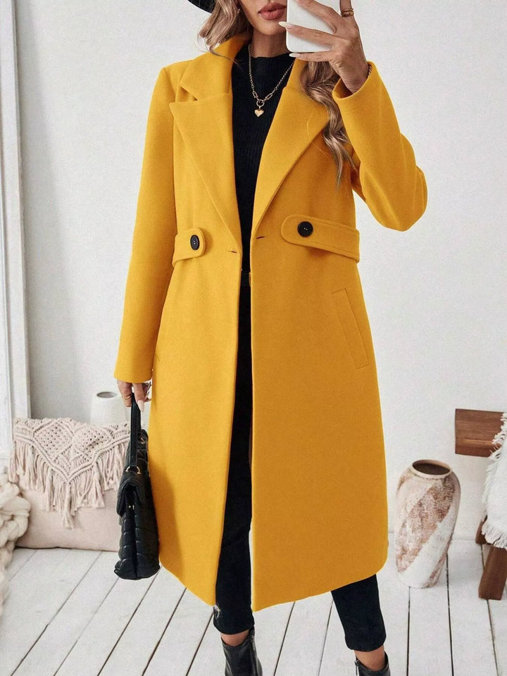 Longline notch lapel coat with single-button waist tab