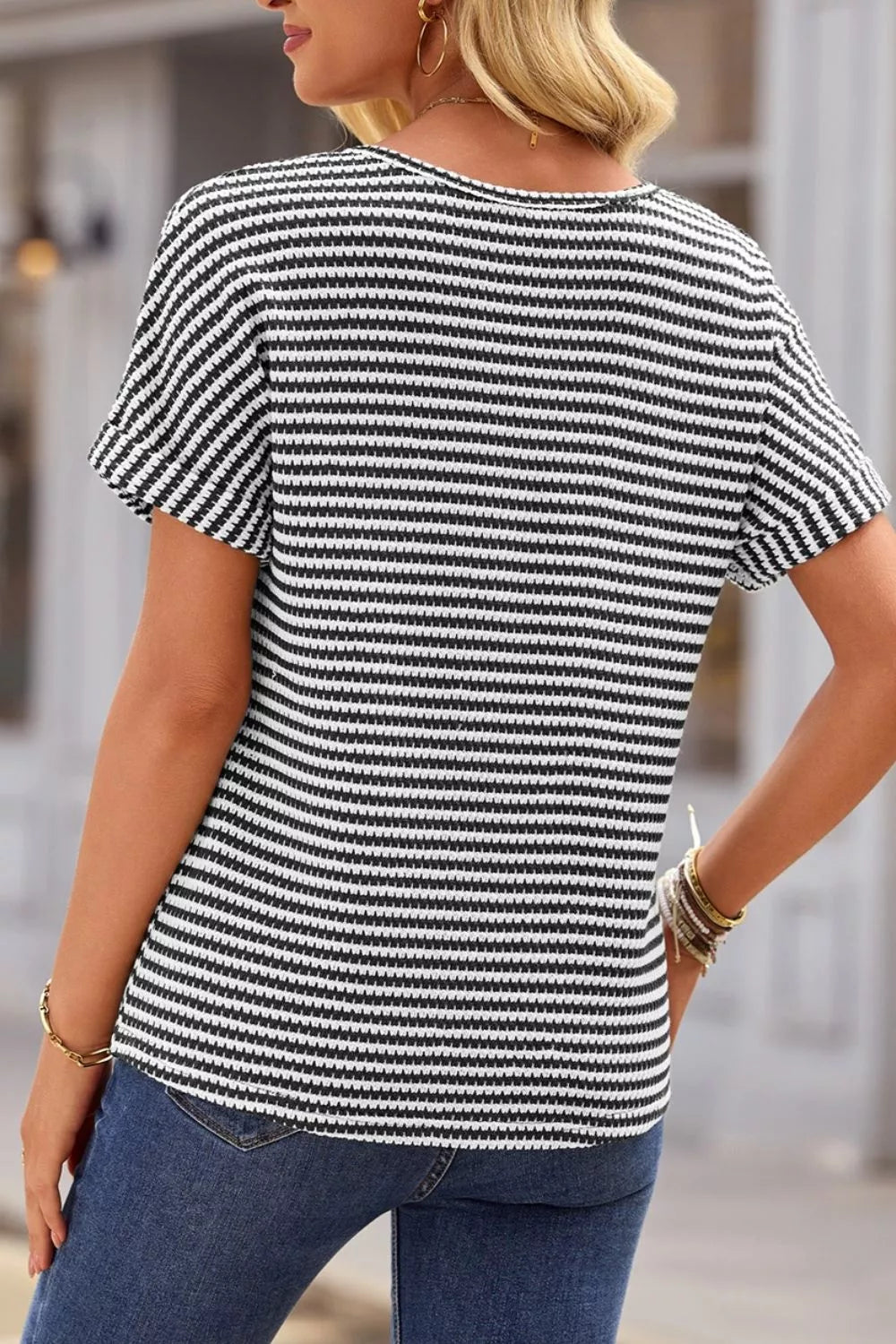 Striped textured knit top with notched V-neck and cuffed sleeves