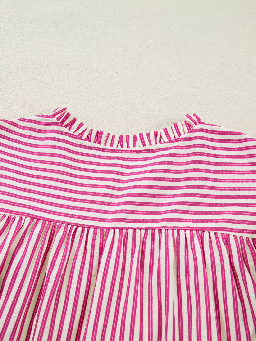 Striped shirred-yoke blouse with ruffled flutter sleeves