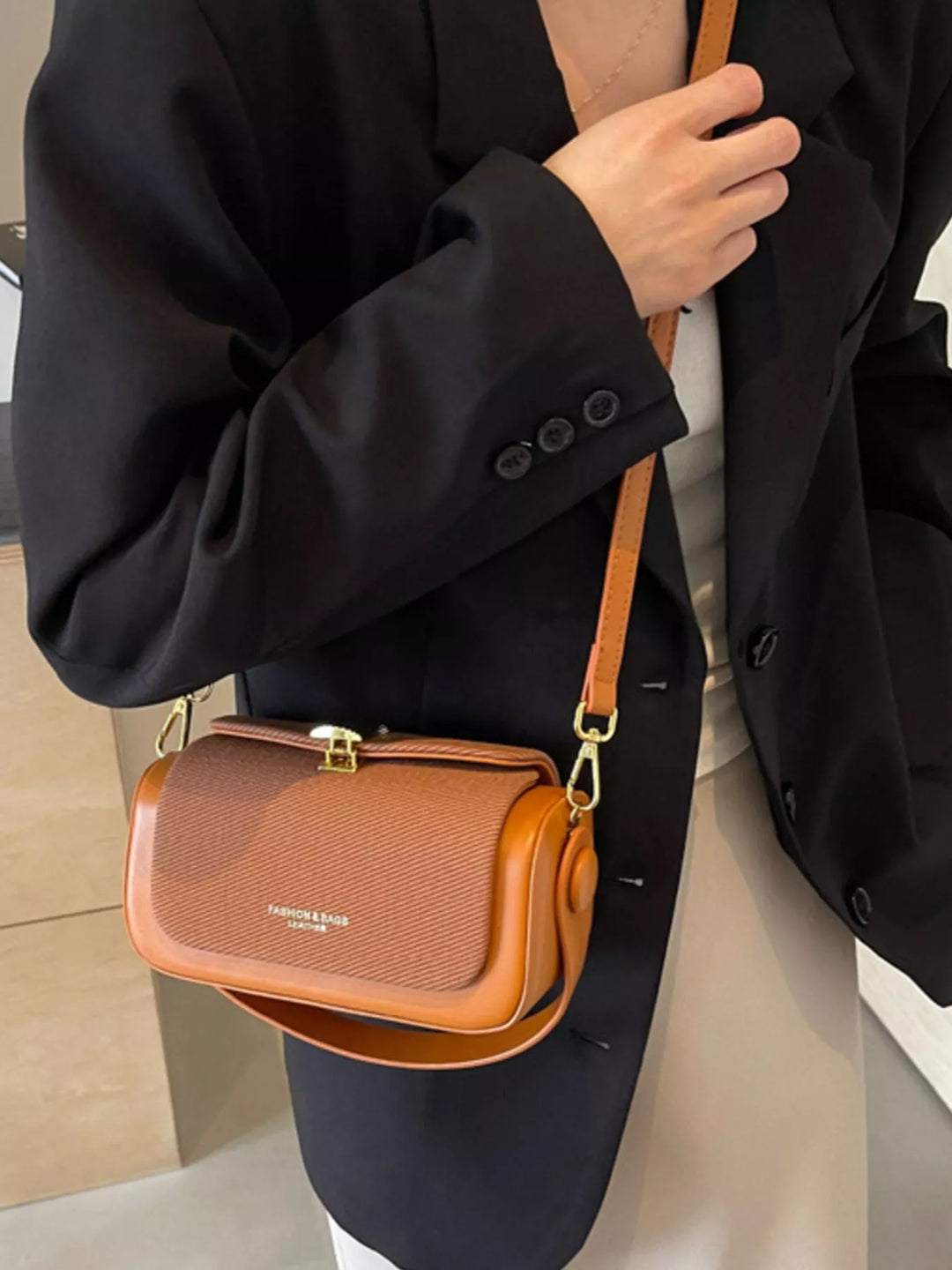 Structured boxy crossbody bag with gold clasp and top handle