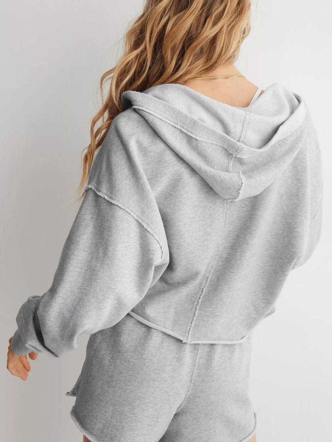 Cropped exposed-seam pullover hoodie with split neck
