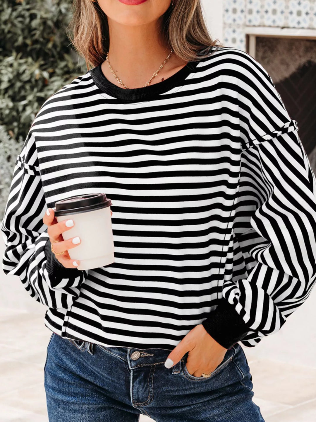 Exposed seam striped drop-shoulder pullover top