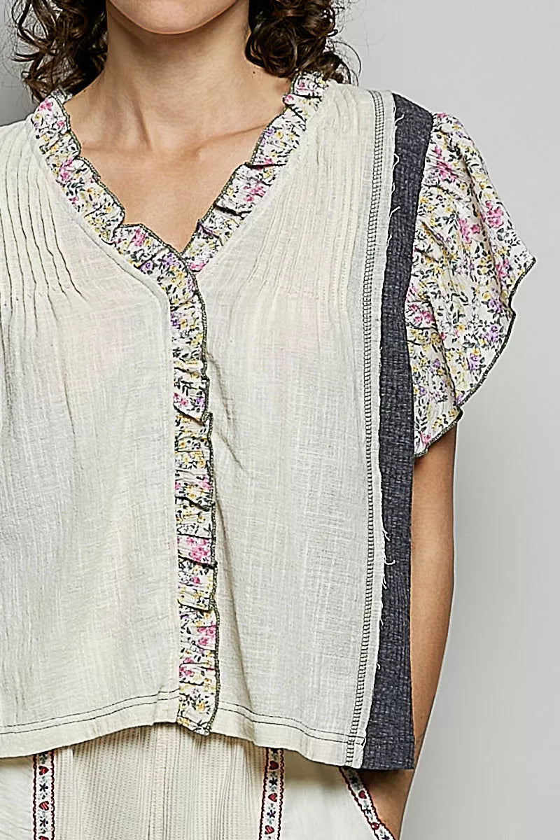 V-neck woven blouse with floral ruffle trim and pintuck front