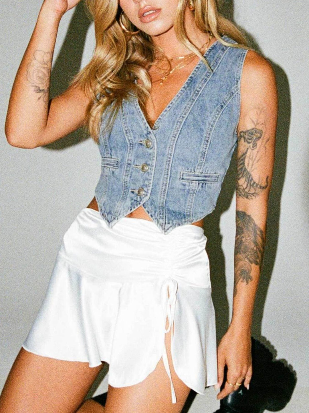 V-neck button-up cropped denim vest with welt pockets