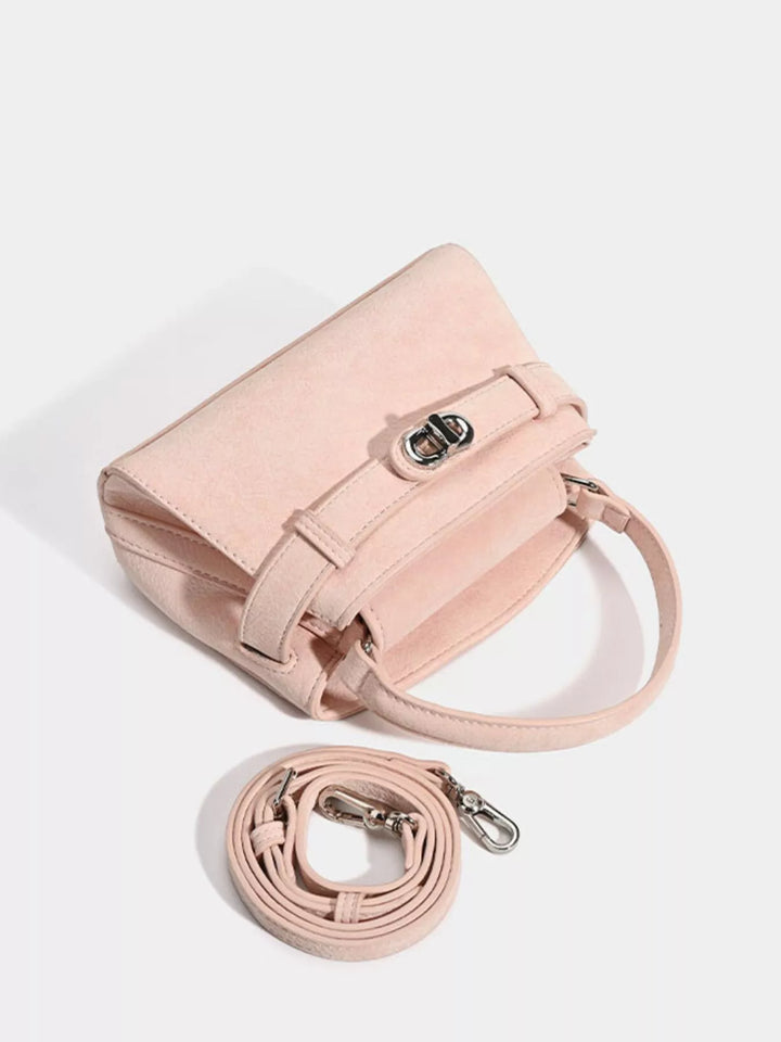 Mini belted crossbody bag with top handle and twist lock