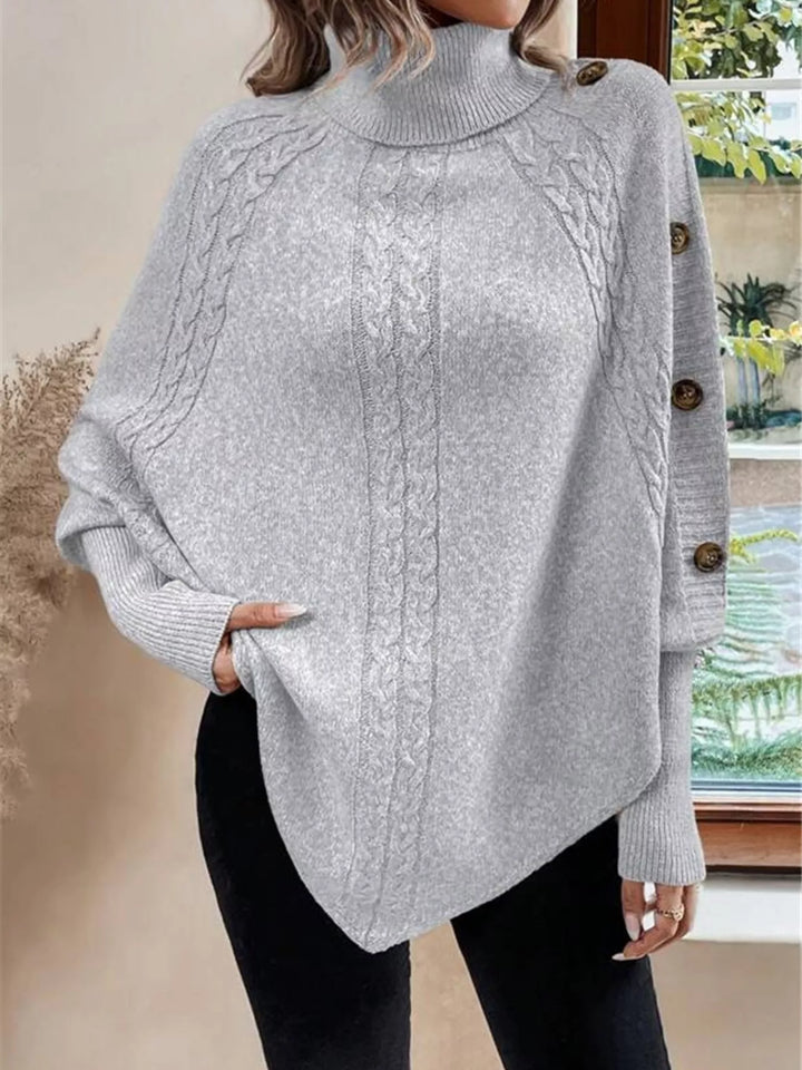 Cable knit turtleneck cape sweater with button shoulder