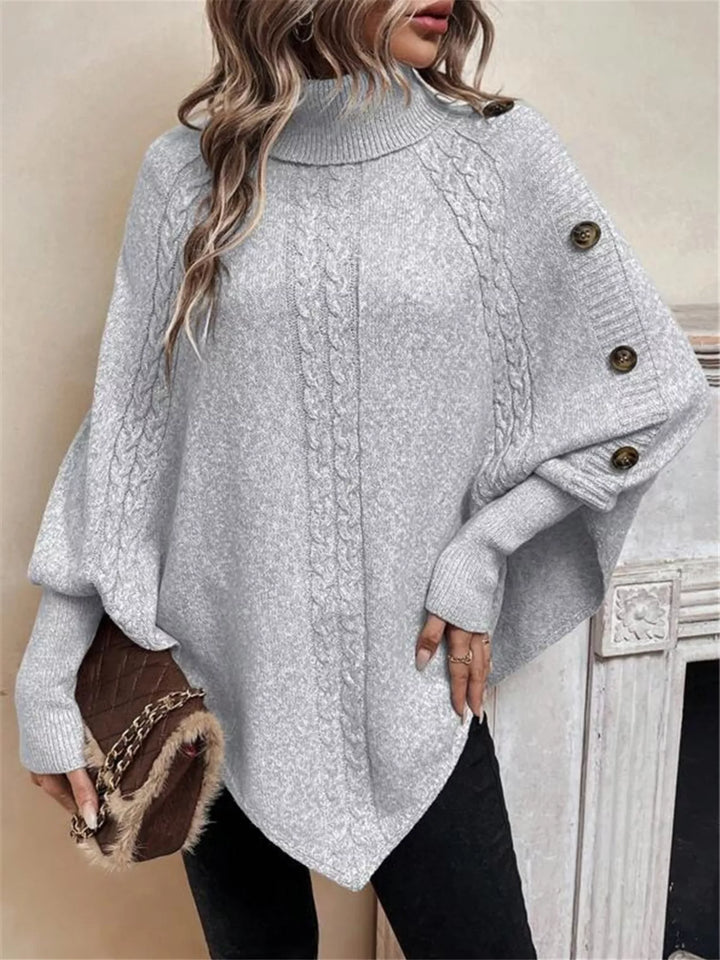 Cable knit turtleneck cape sweater with button shoulder