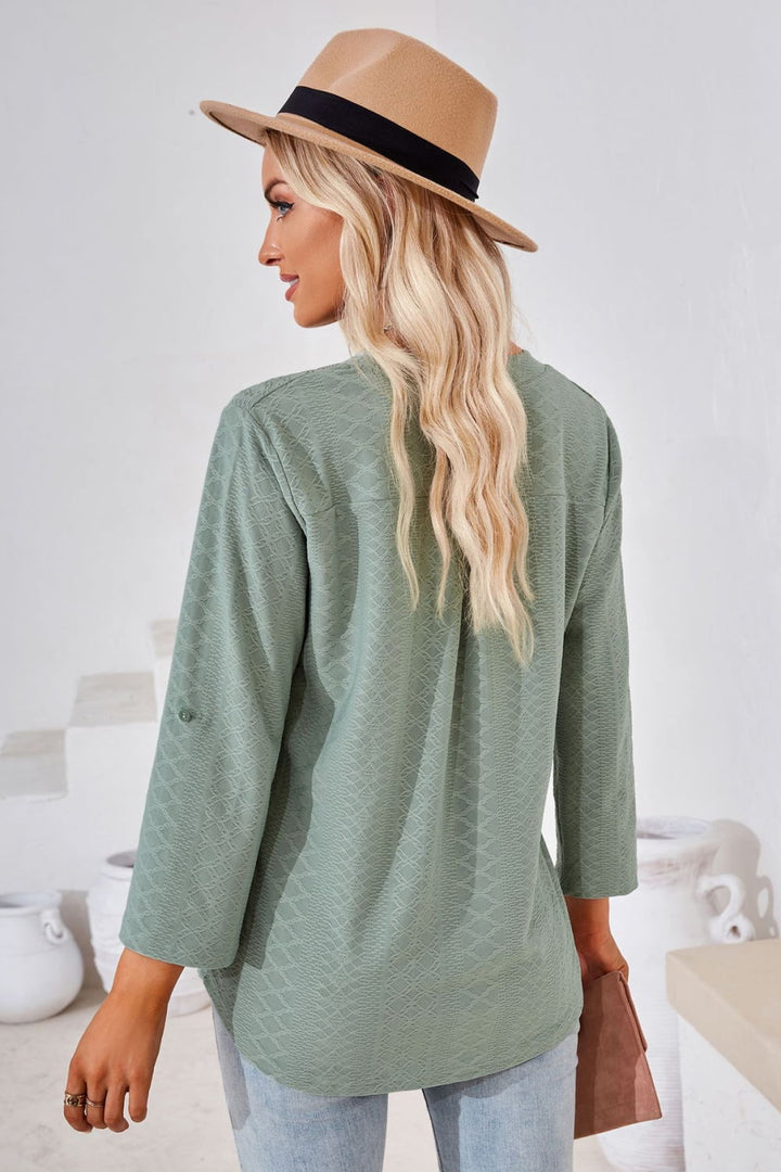 Textured split v-neck blouse with roll-tab sleeves