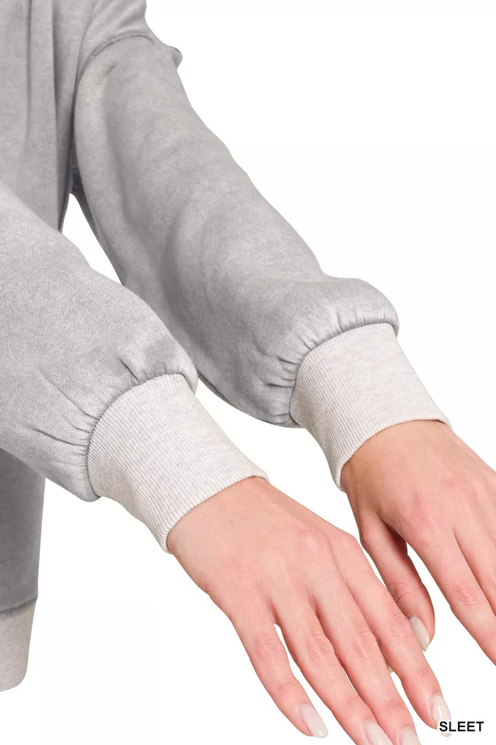 Acid wash fleece pullover with exposed seams and side slits