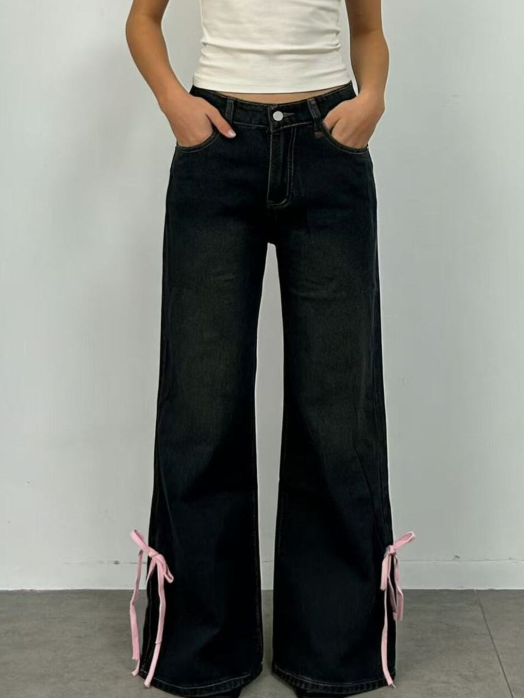 Low-rise flare jeans with ribbon bow leg slits
