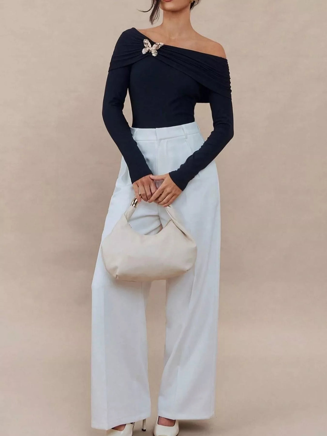 Off-shoulder long sleeve top with gold butterfly brooch