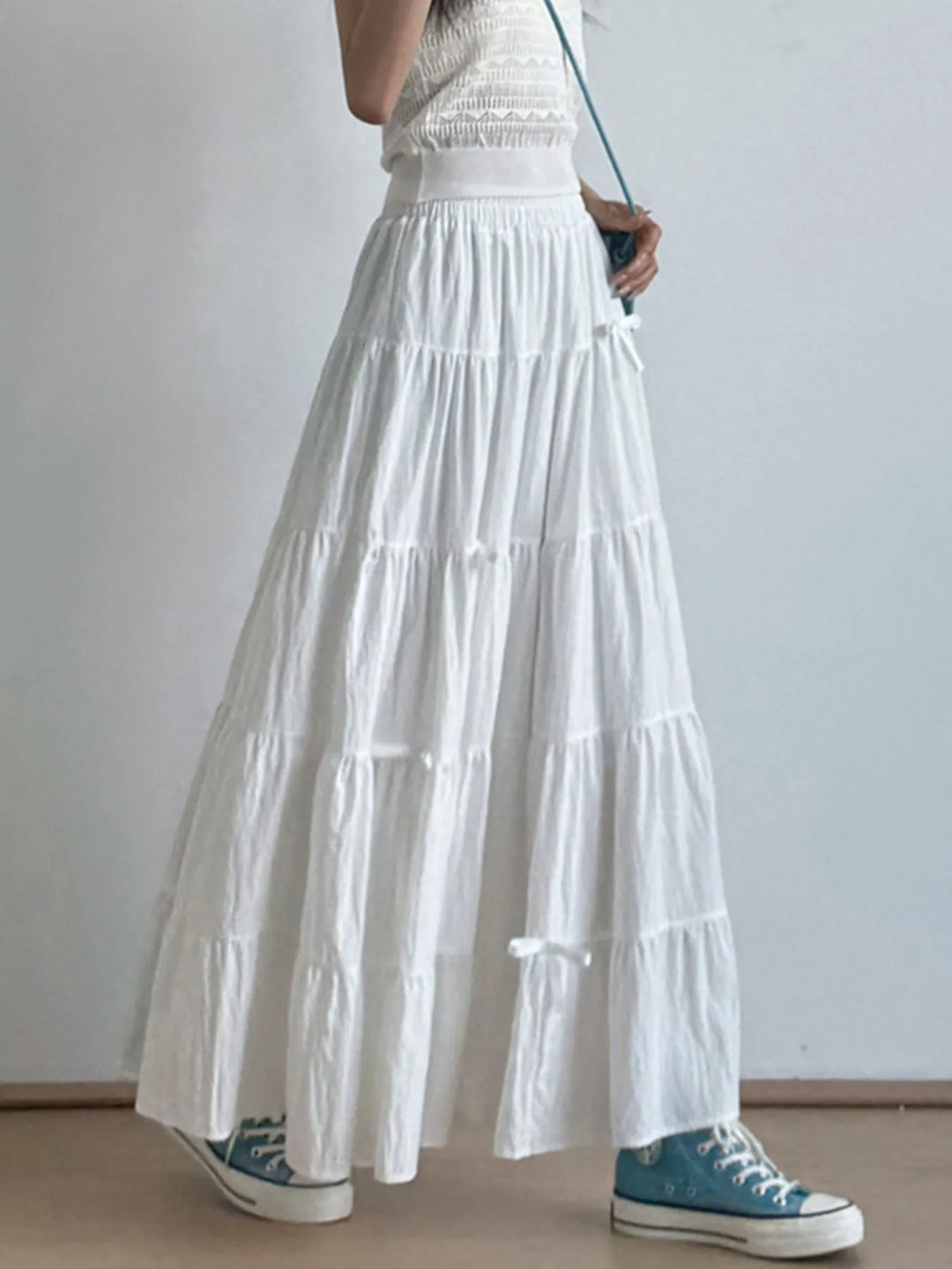 Tiered bow-accent maxi skirt with elastic smocked waist