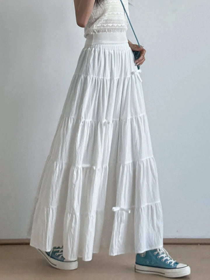 Tiered bow-accent maxi skirt with elastic smocked waist