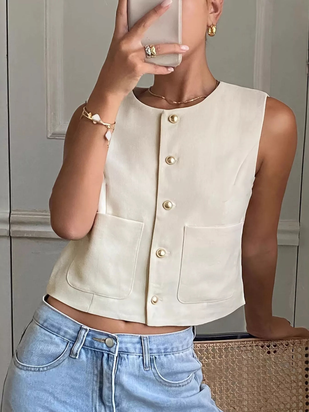 Button-down sleeveless vest with gold dome buttons and patch pockets