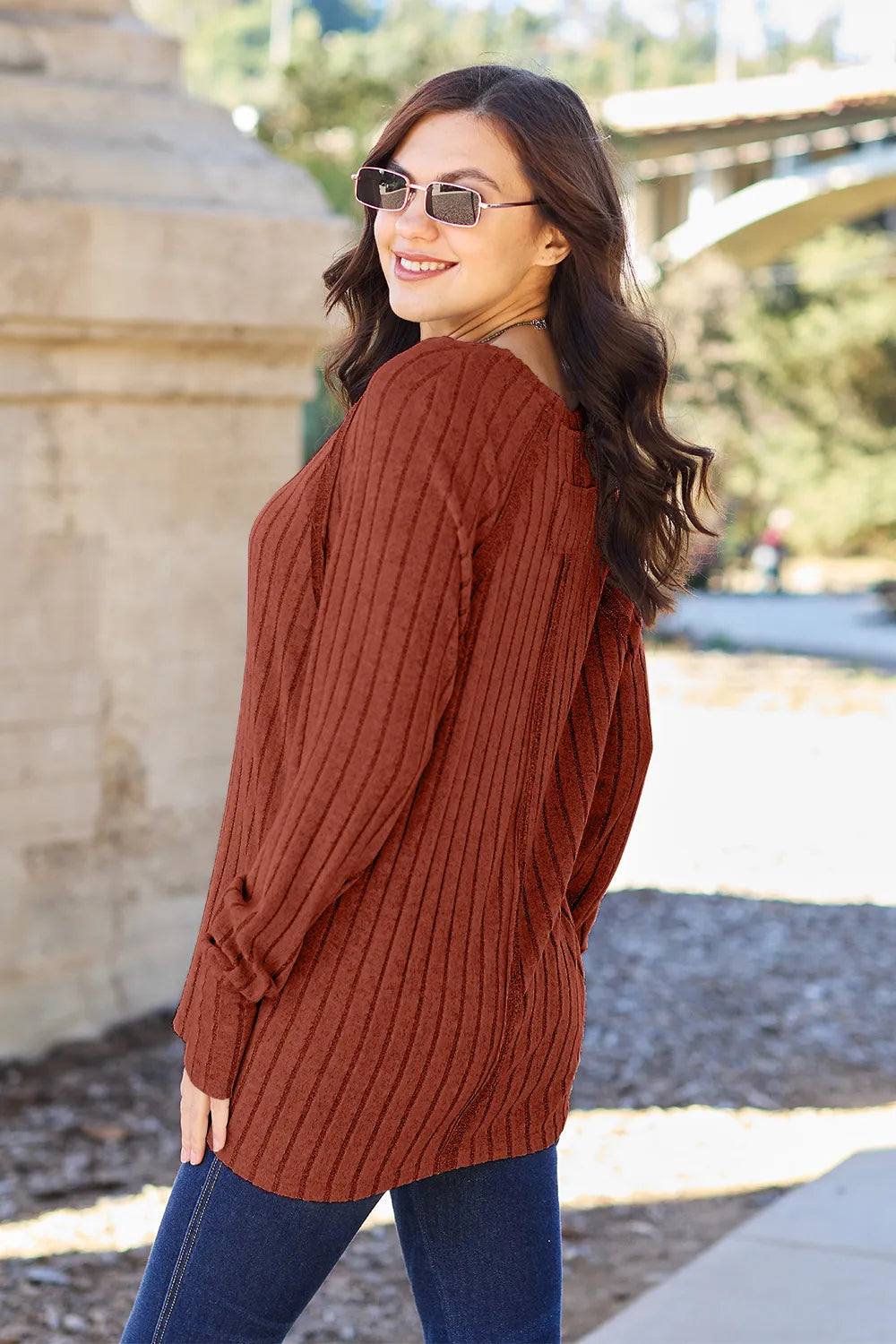 Ribbed knit round neck long sleeve top with curved hem