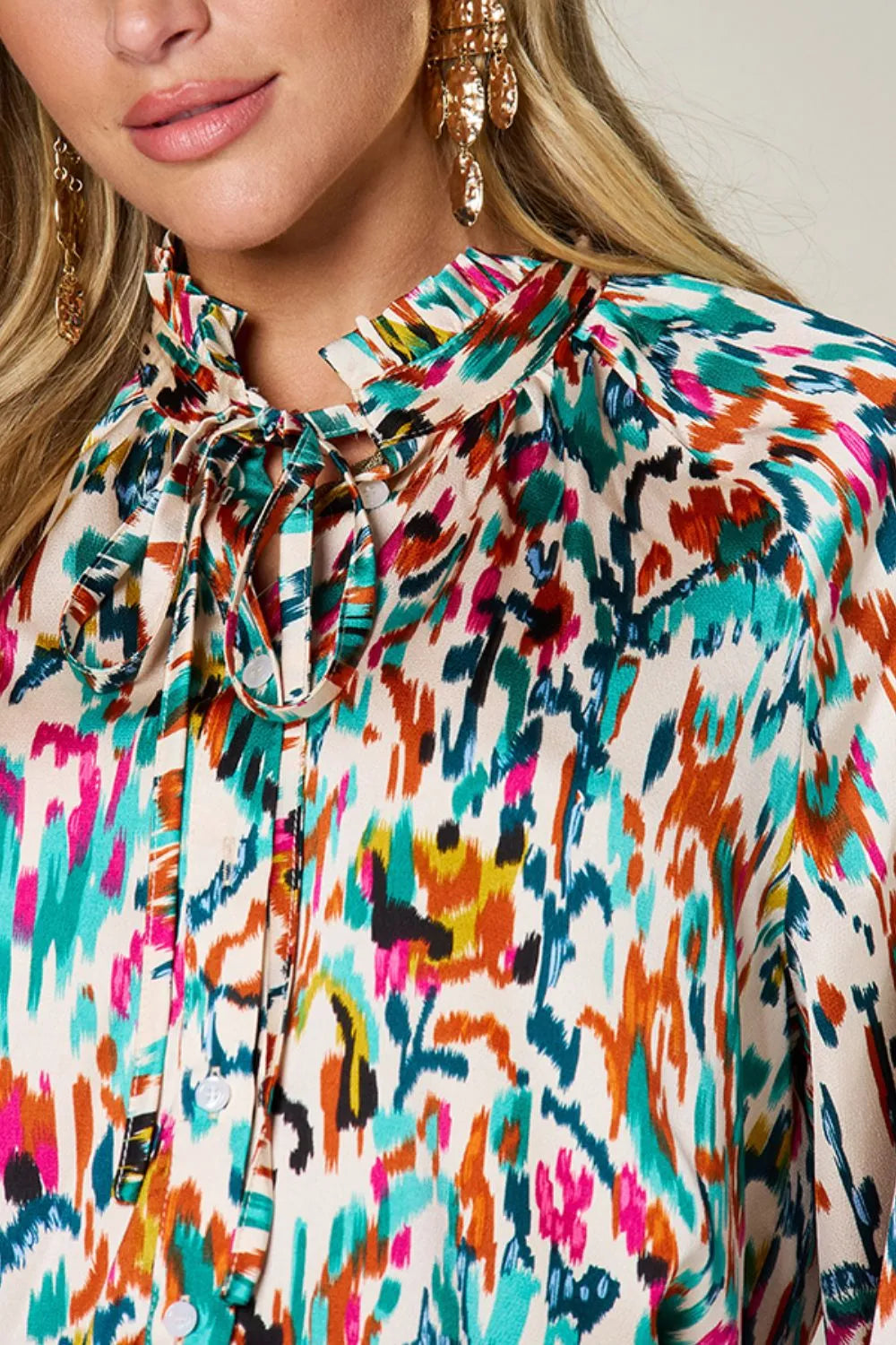 Abstract print button-up shirt with tie neck and long sleeves
