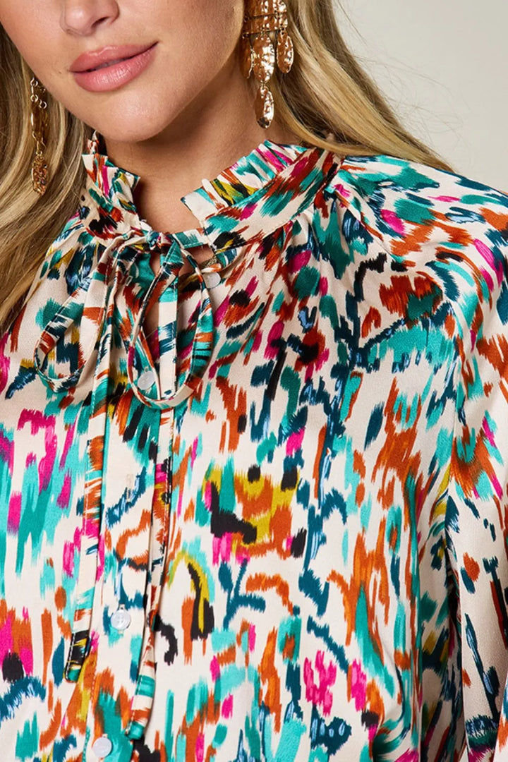Abstract print button-up shirt with tie neck and long sleeves